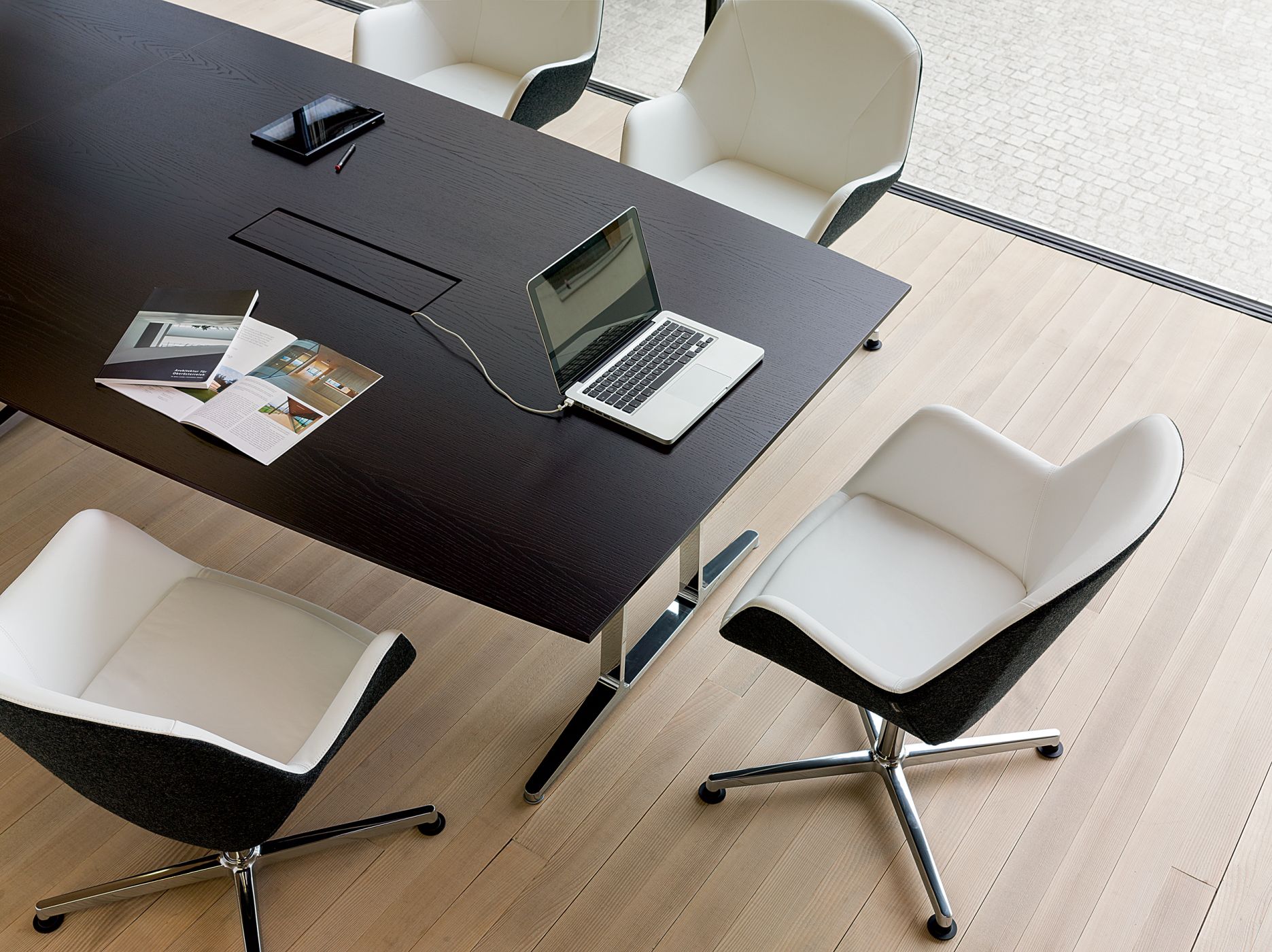 Conference tables feature signature dual-flipping power grommets.