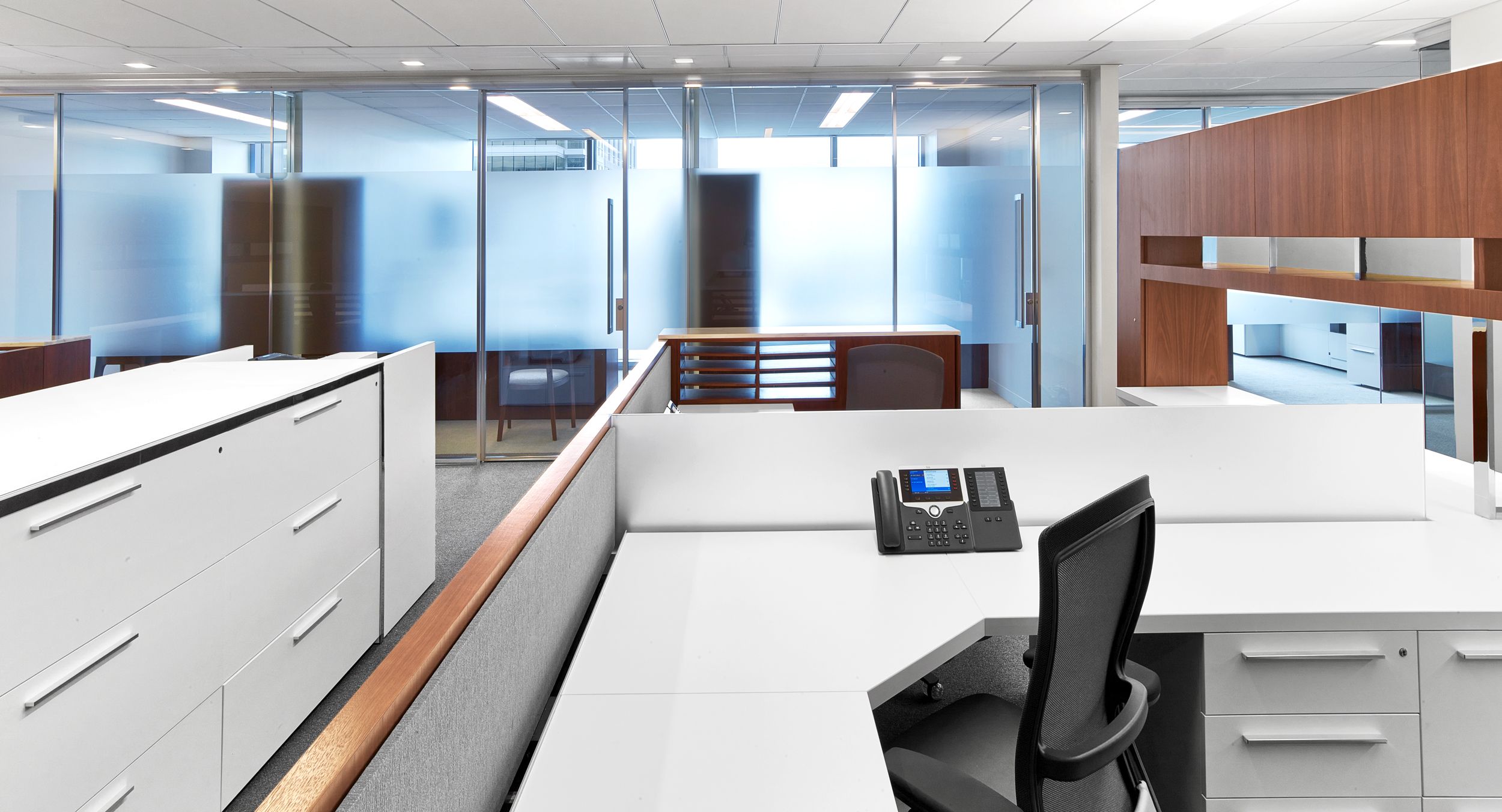 Workstations feature a full range of materials with walnut veneers, laminate, chrome, fabric, etched glass, and stone.