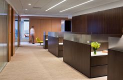 Rift cut veneers and etched glass create sophisticated administrative workstations. thumbnail