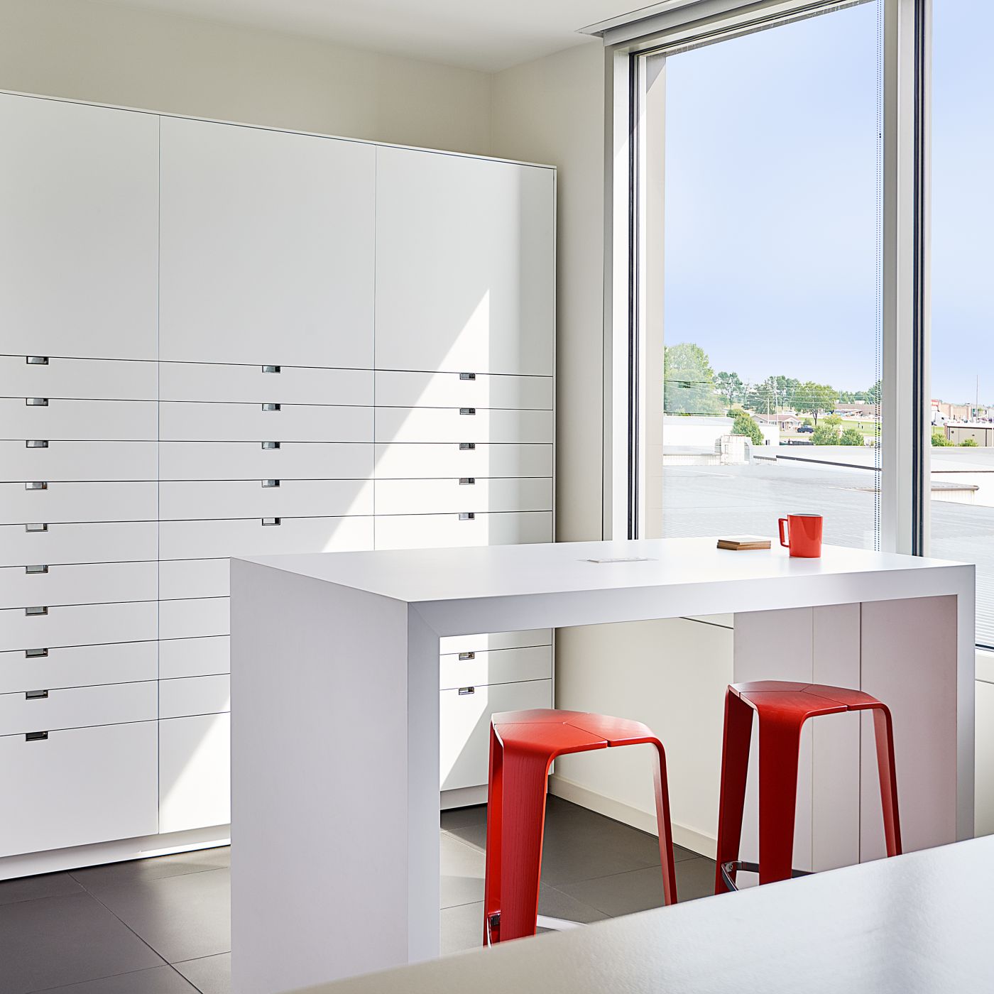 Our sample room features custom LEX storage and HUGO table in Designer White.