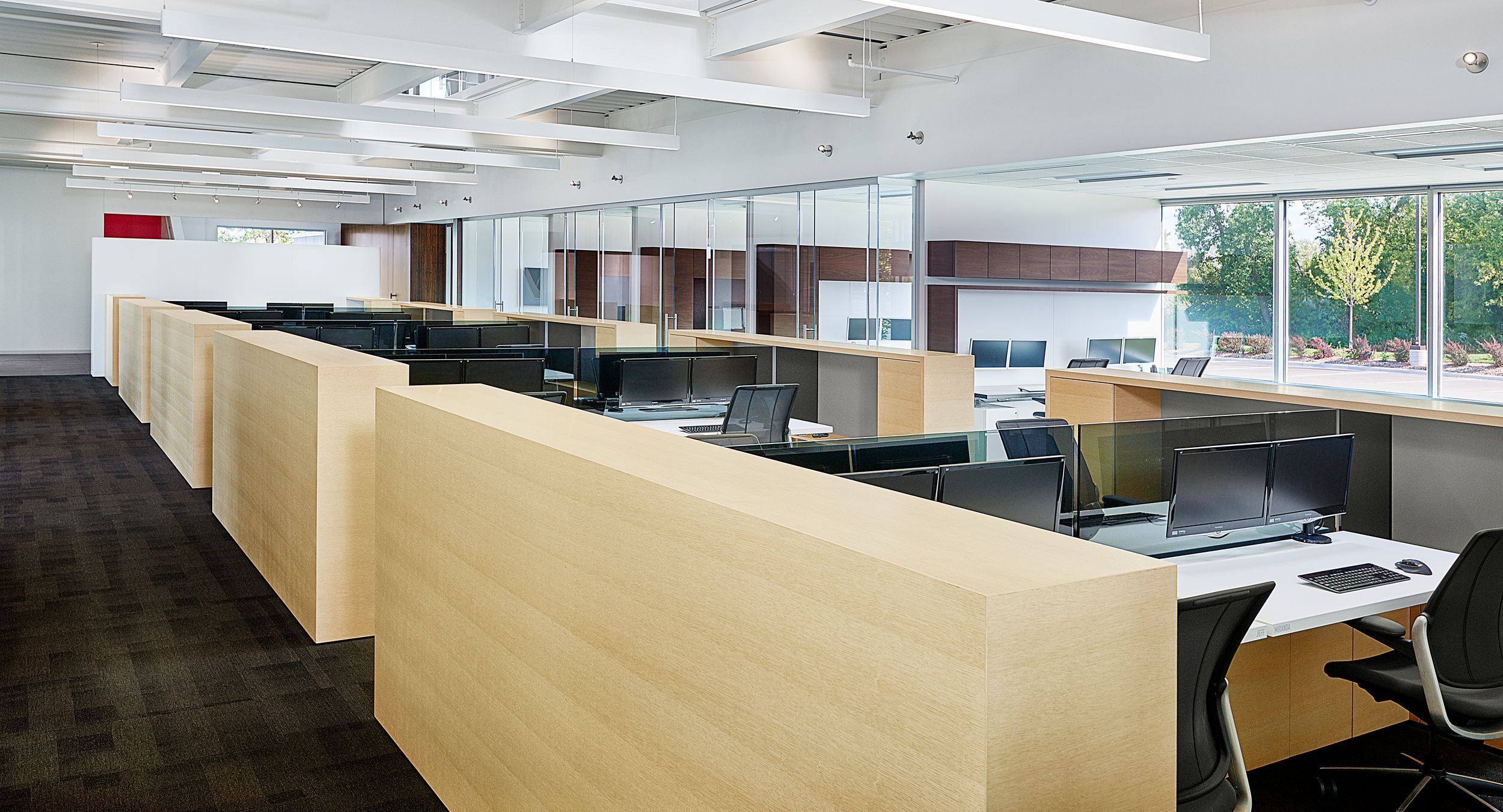 Adjustable-height desking, tinted glass screens, and seamless cabinetry highlight our engineering workstations.