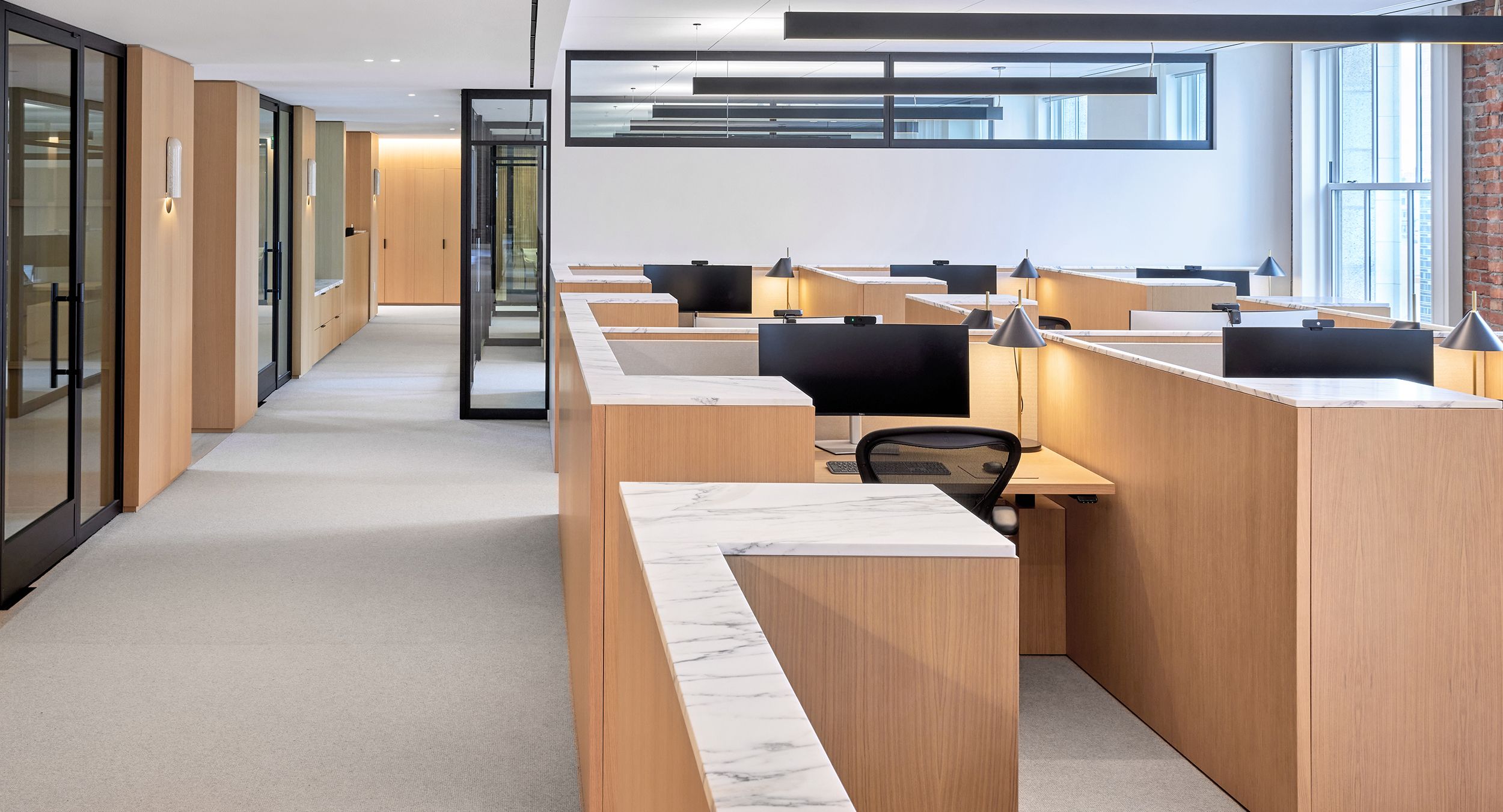 HALO OFFICE nine-seat workstations in white oak, deep bronze with Calcatta Arabescato tops.