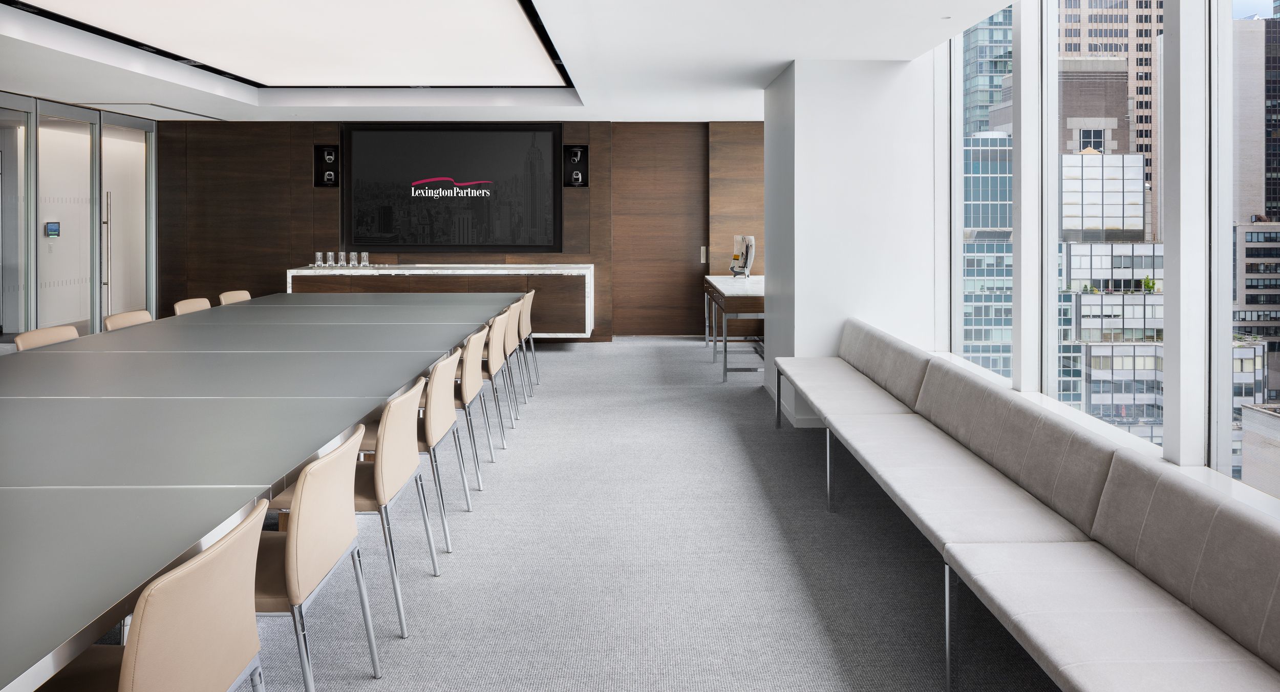 HALO benching and stone top credenza enhance the elegant tone of this meeting space.