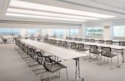 SKILL reconfigurable tables with polished aluminum bases and white Fenix surfaces. A MOTUS mobile lectern in designer white completes this flexible space. thumbnail