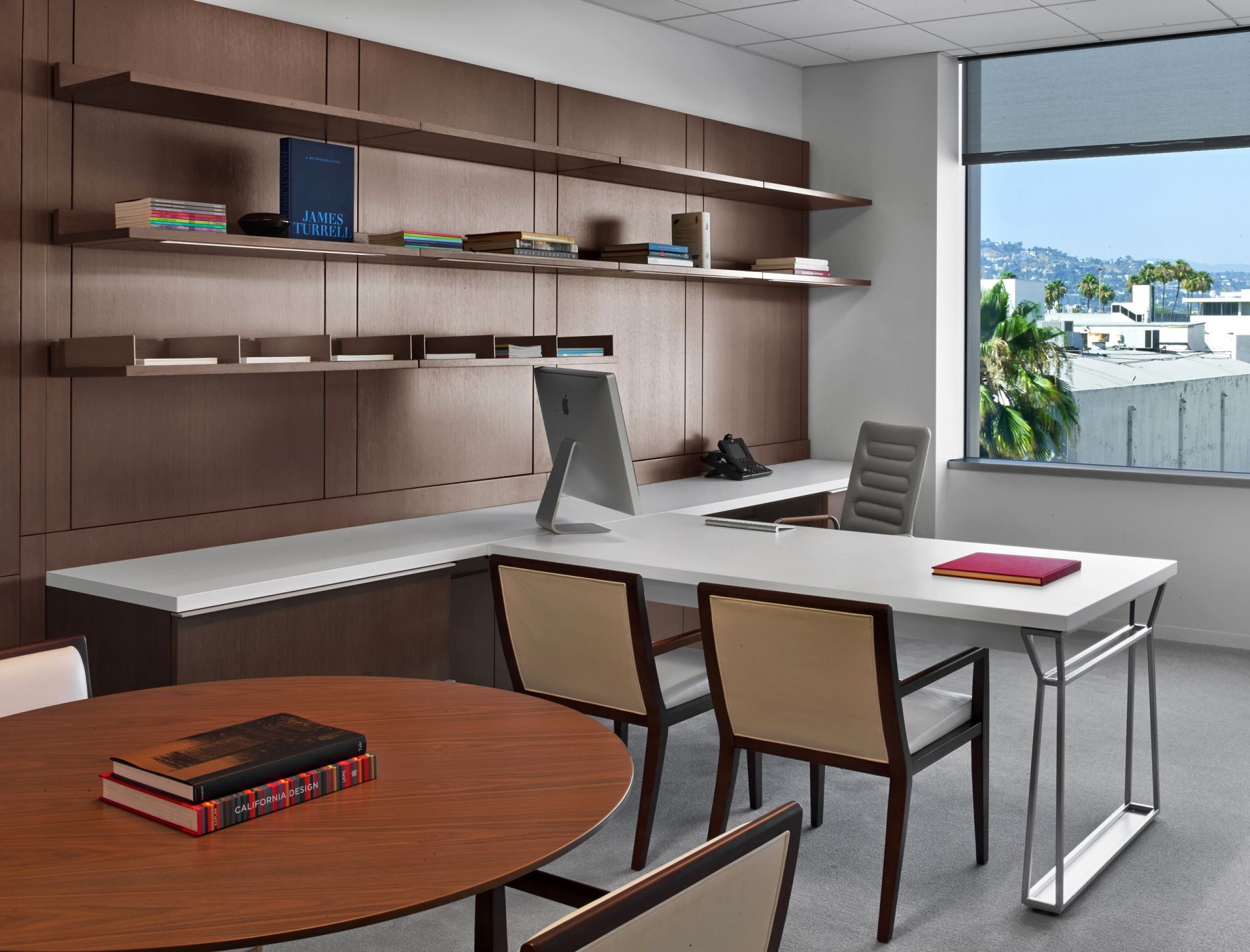 Private offices feature rift oak workwalls, Smoky White laminate surfaces, and brushed aluminum hardware.