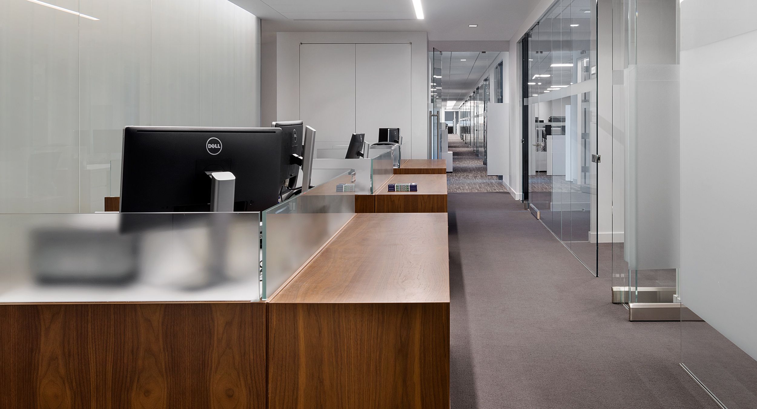 Open office workstations were provided in Flat Cut Walnut and etched glass.