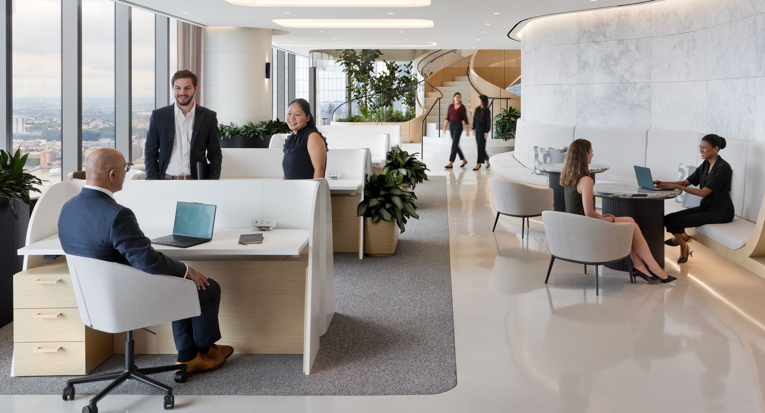 Custom workstations in White Oak with curved Designer White end panels and FENIX Bianco Kos worksurfaces