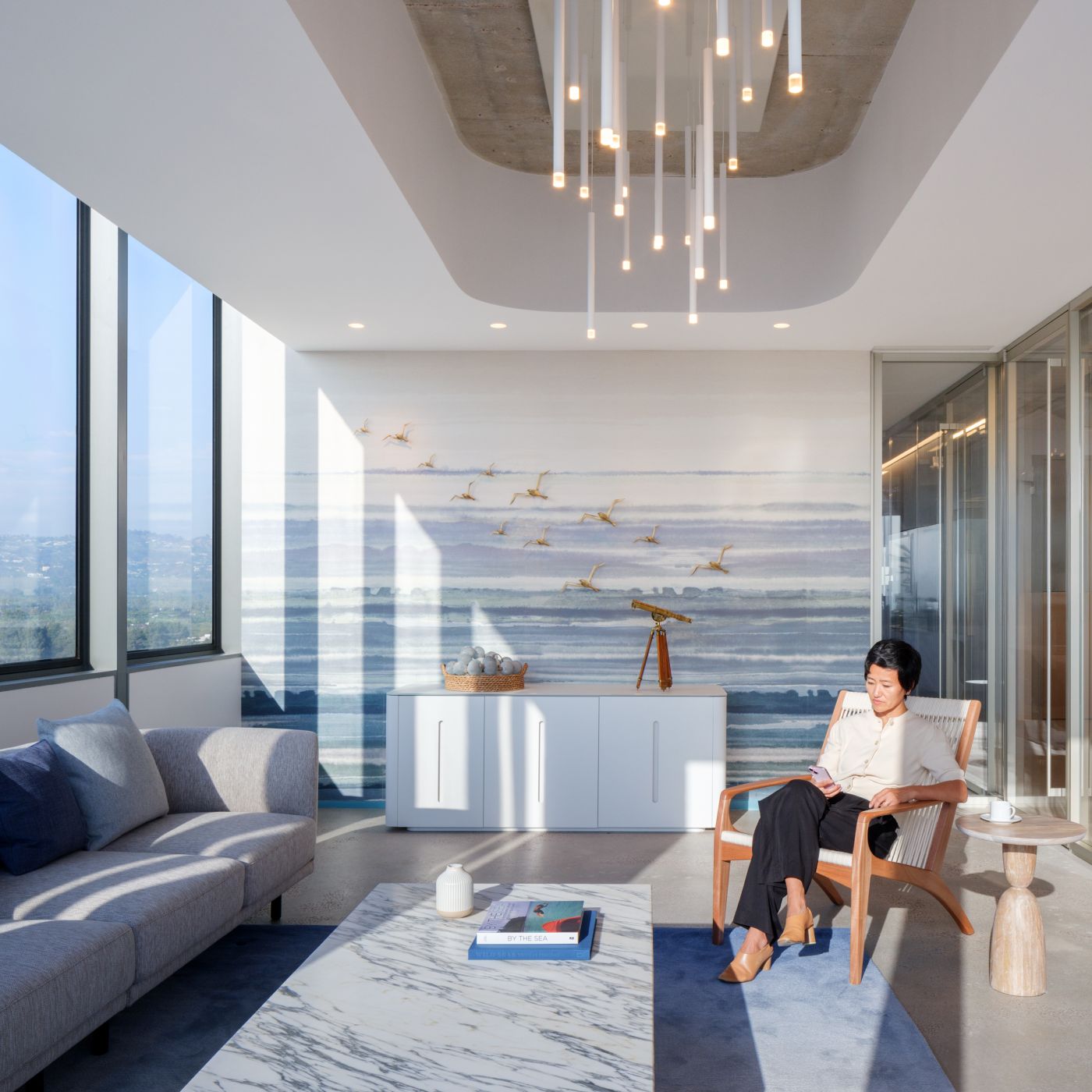 The clean timeless lines of this Crew glass-surfaced Crew credenza is the perfect accompaniment to this stylish space.