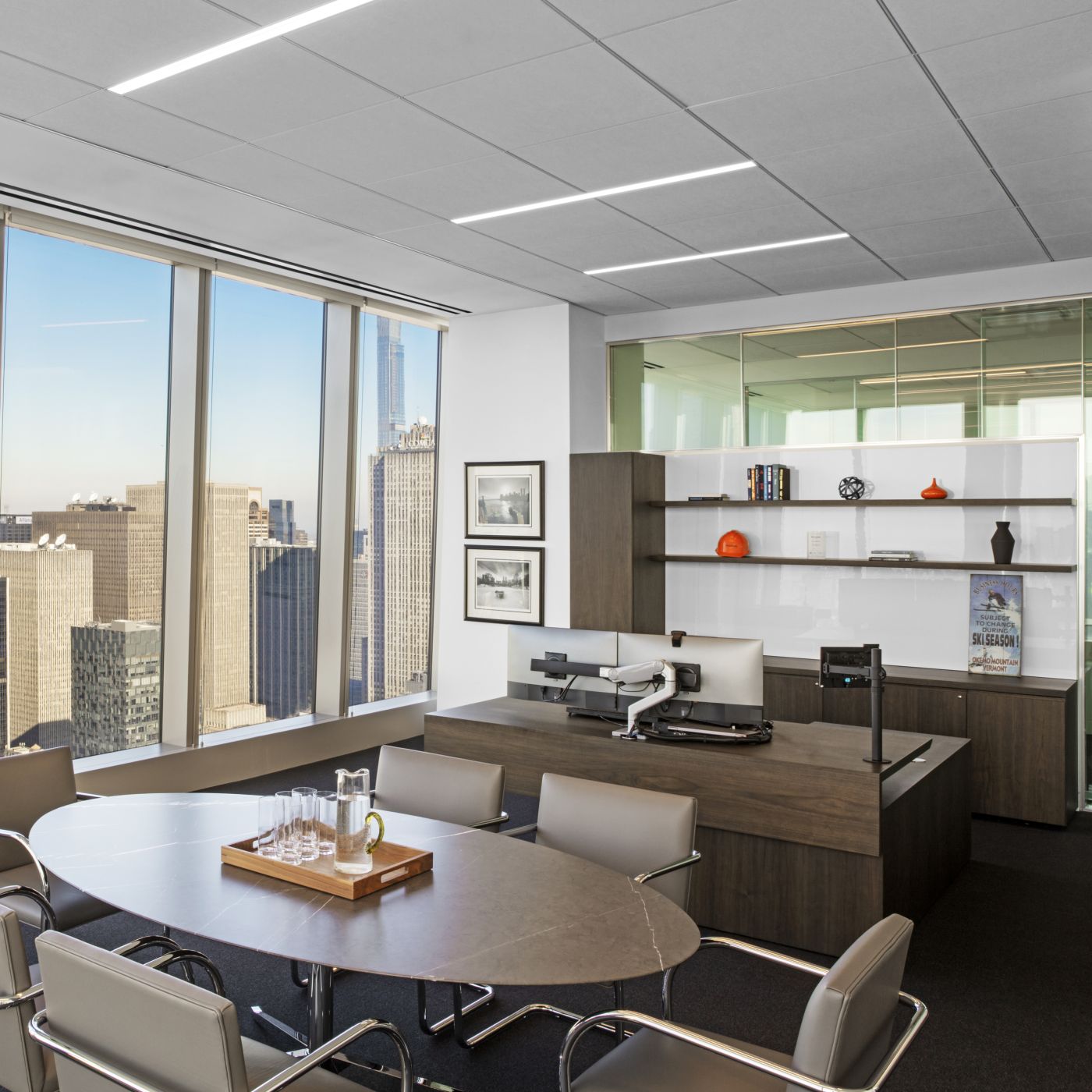 Custom NEW MILLENNIA executive office with cantilevered adjustable-height worksurface in slate walnut.
