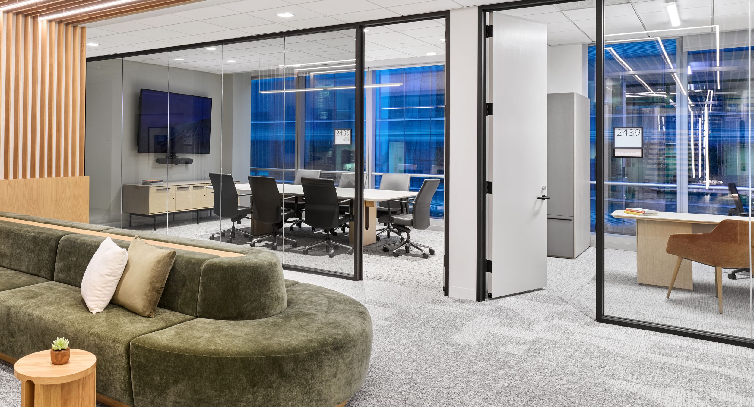 A FREYA table in White Oak is complemented by a matching HALO credenza in this medium conference room.