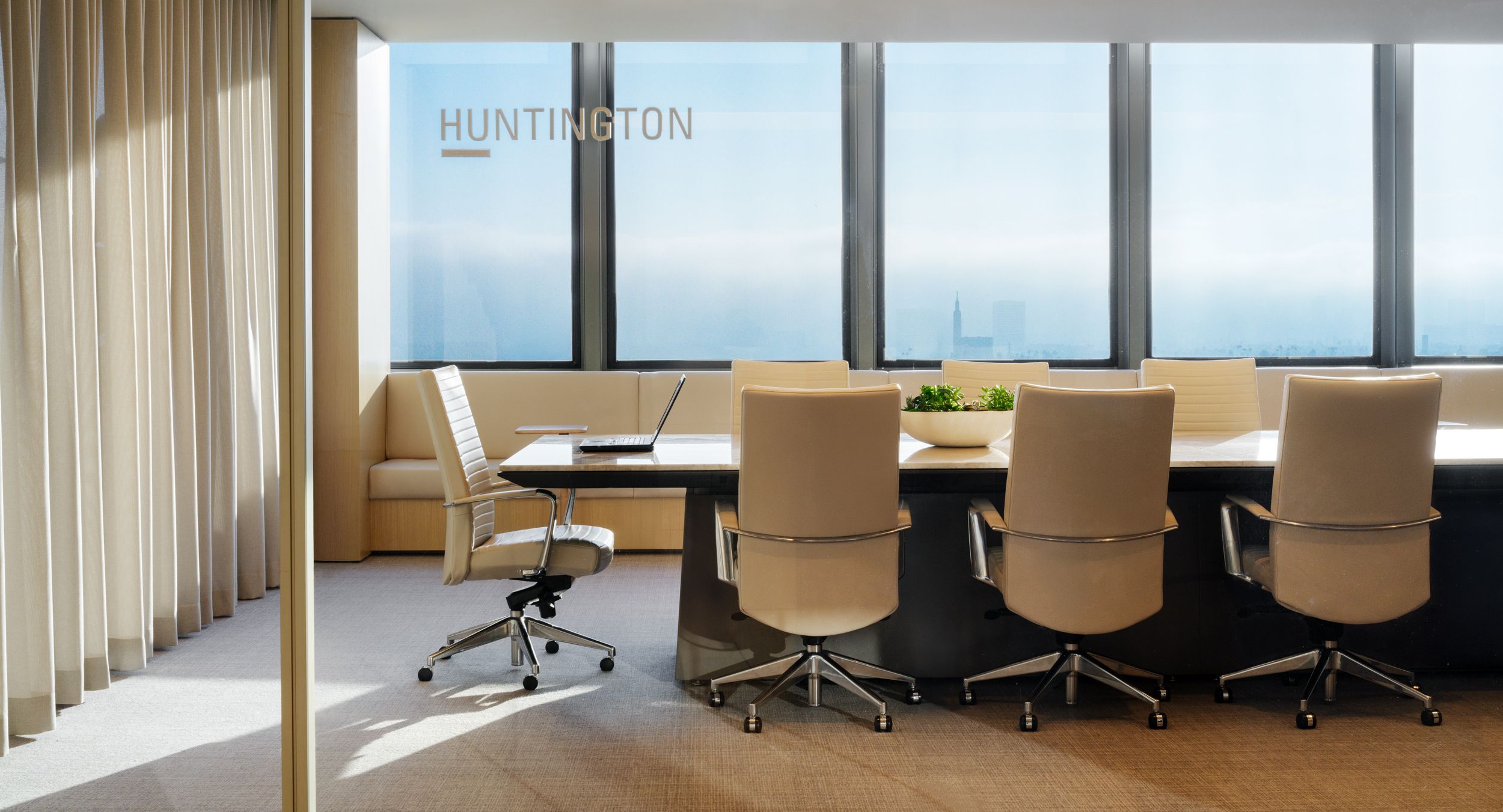 60 x228 Halo continuous base conference table with Vento Beige stone surface and Mink Halo soft edge.