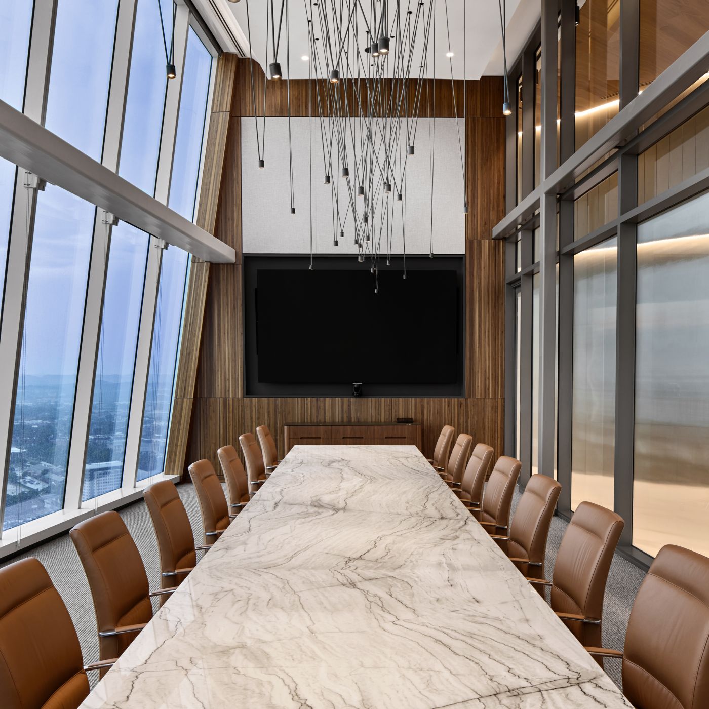 Stone surfaced Halo conference table is perfectly complemented by a glass-surface Crew credenza in Flat Cut Walnut.