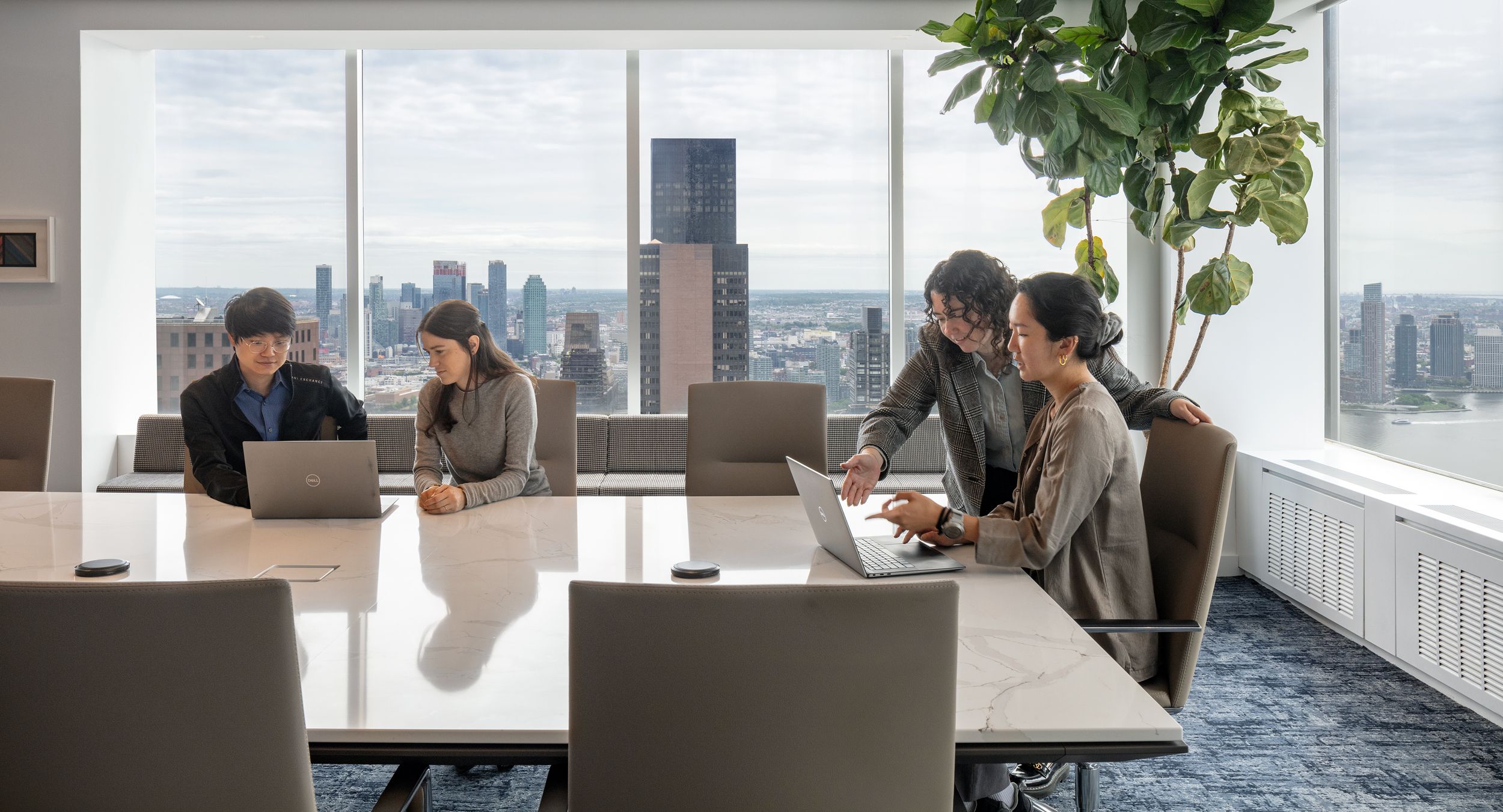 Stunning Custom Halo conference table with stone surface, Halo Soft Edge, and Mesa Loop base.