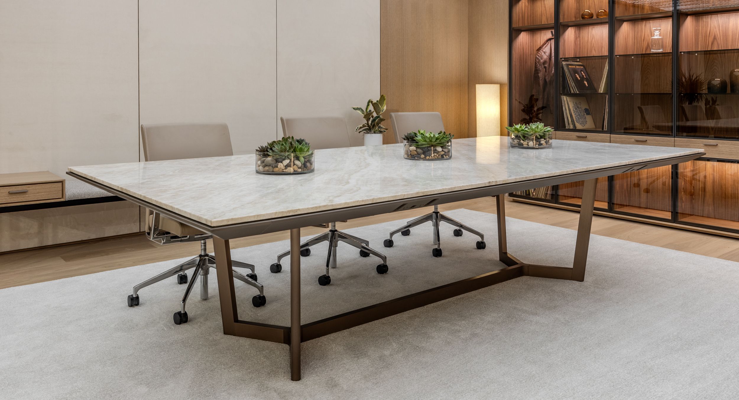 HALO Conference Table with Taj Mahal stone surface and Light Bronze Anodized Base.