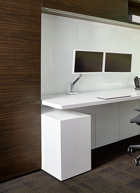 Adjustable-height worksurface are provided throughout the space.