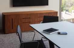 MESA table with light bronze loop base is perfectly complemented by a CREW credenza in American walnut. thumbnail