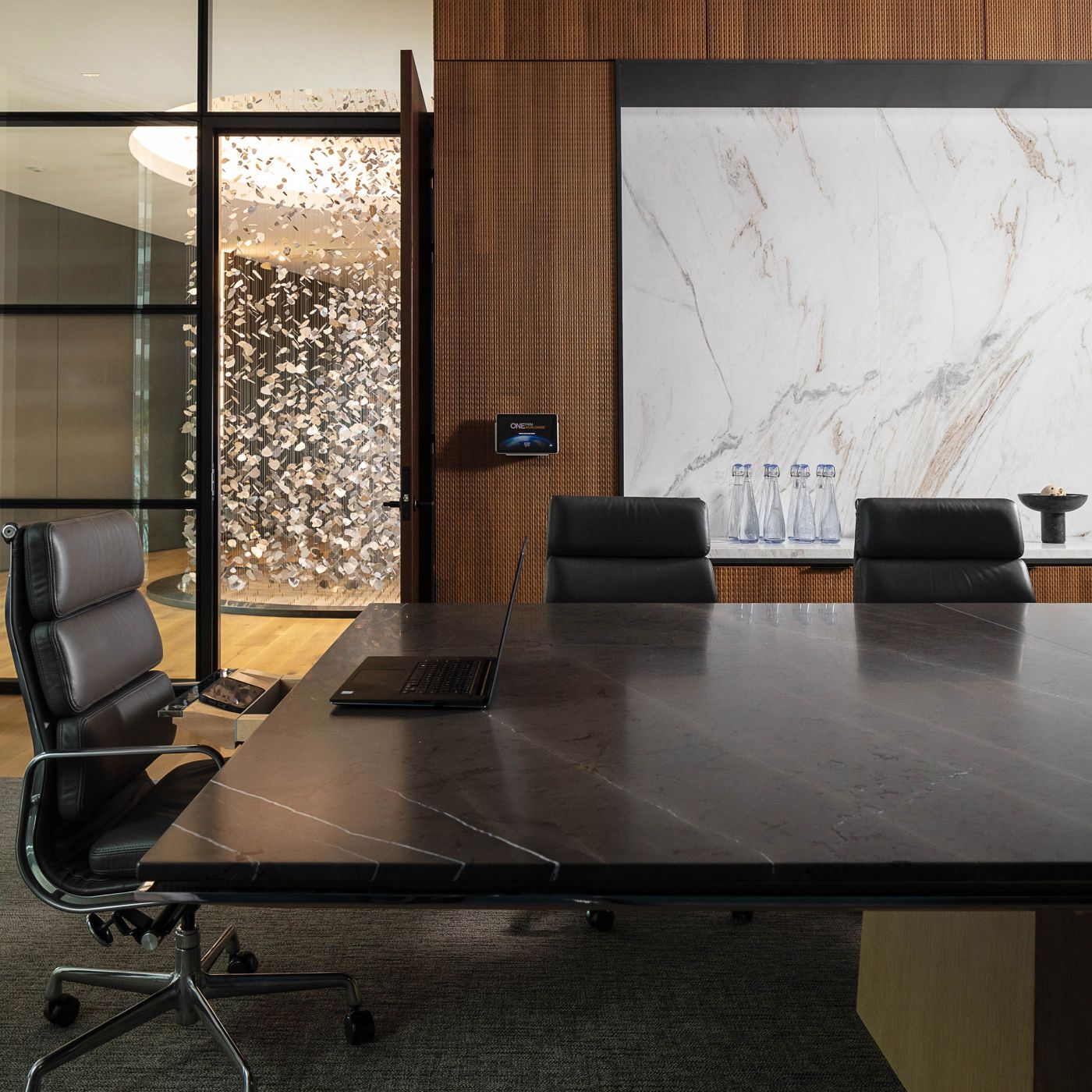 MESA table with a continuous base of bookmatched white oak, and polished chrome trim.