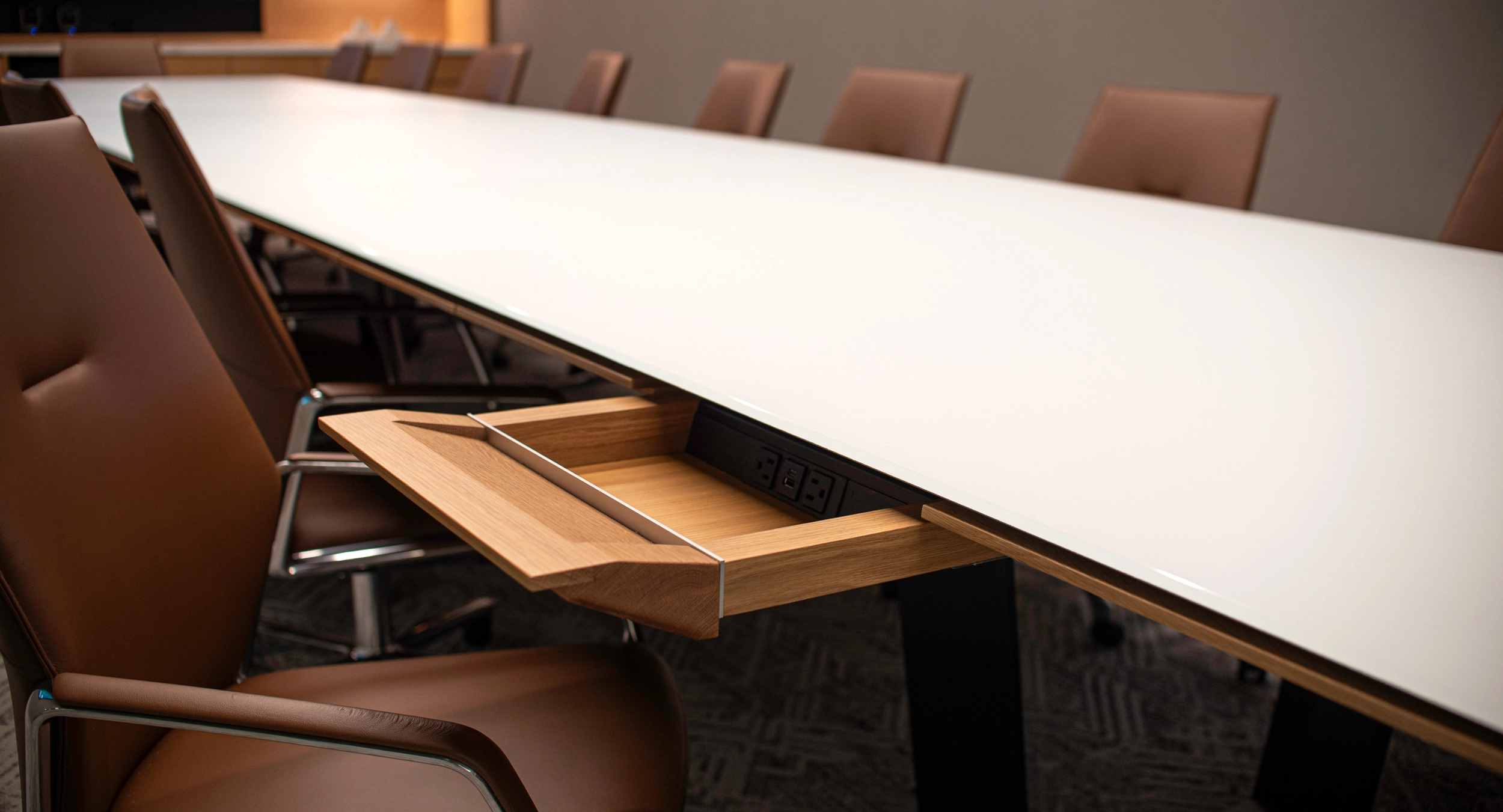 Eliminate surface clutter and comfortably access technology with innovative concealed drawers.