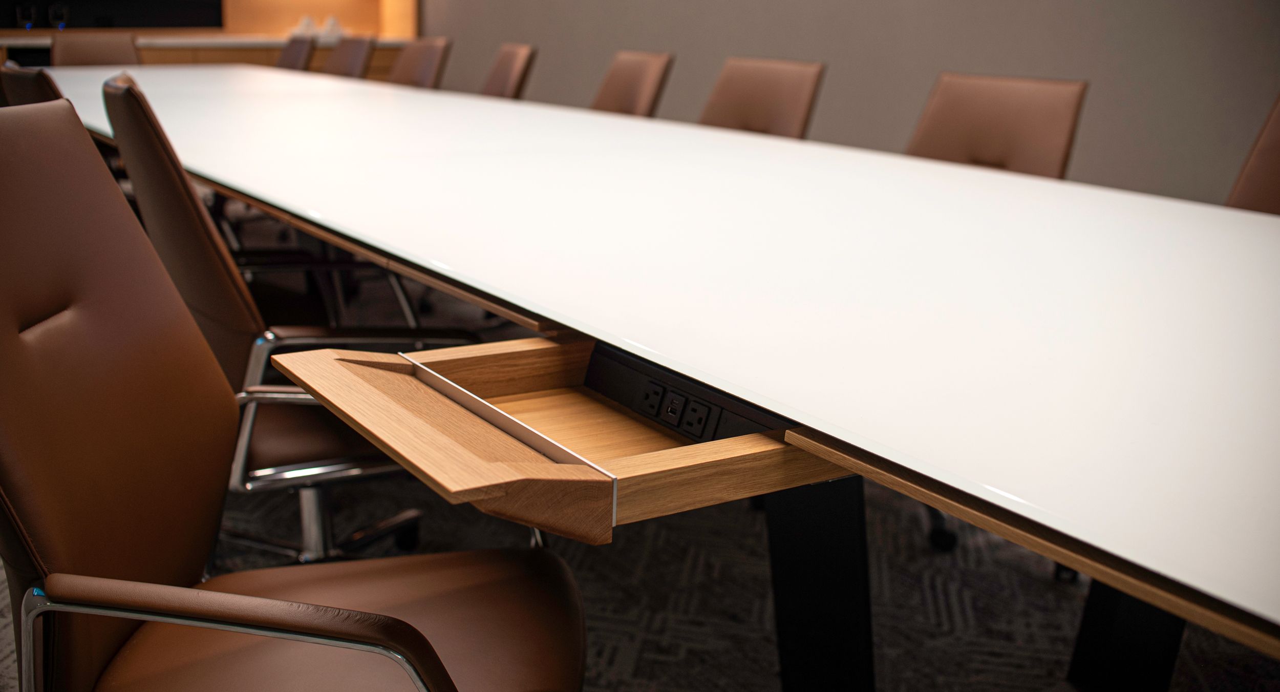 Eliminate surface clutter and comfortably access technology with innovative concealed drawers.