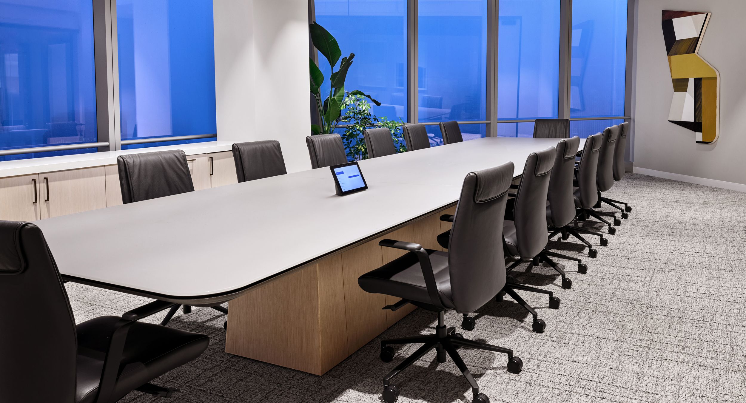 60d x 240w MESA table with etched-glass surface and Rift Cut White Oak continuous base.