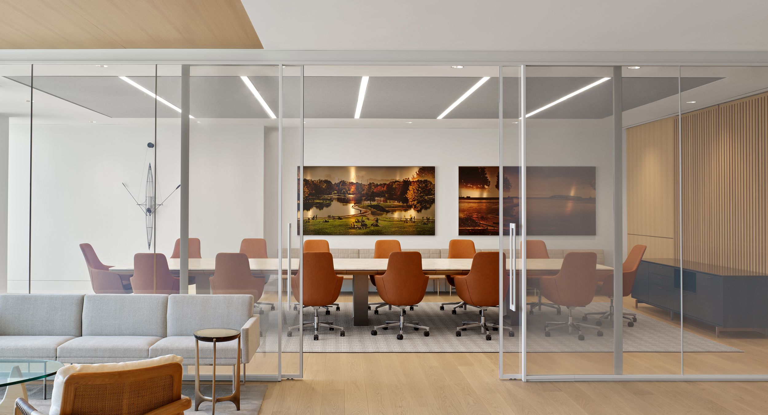 MESA conference table in stone and light bronze , and custom HALO credenza are elegant centerpieces for this space.
