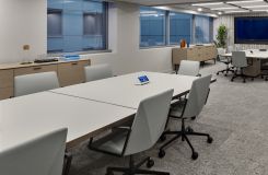 Reconfigurable MOTUS tables with back-painted Windham grey glass surfaces and deep bronze trim are perfectly complemented by a pair HALO credenzas. thumbnail