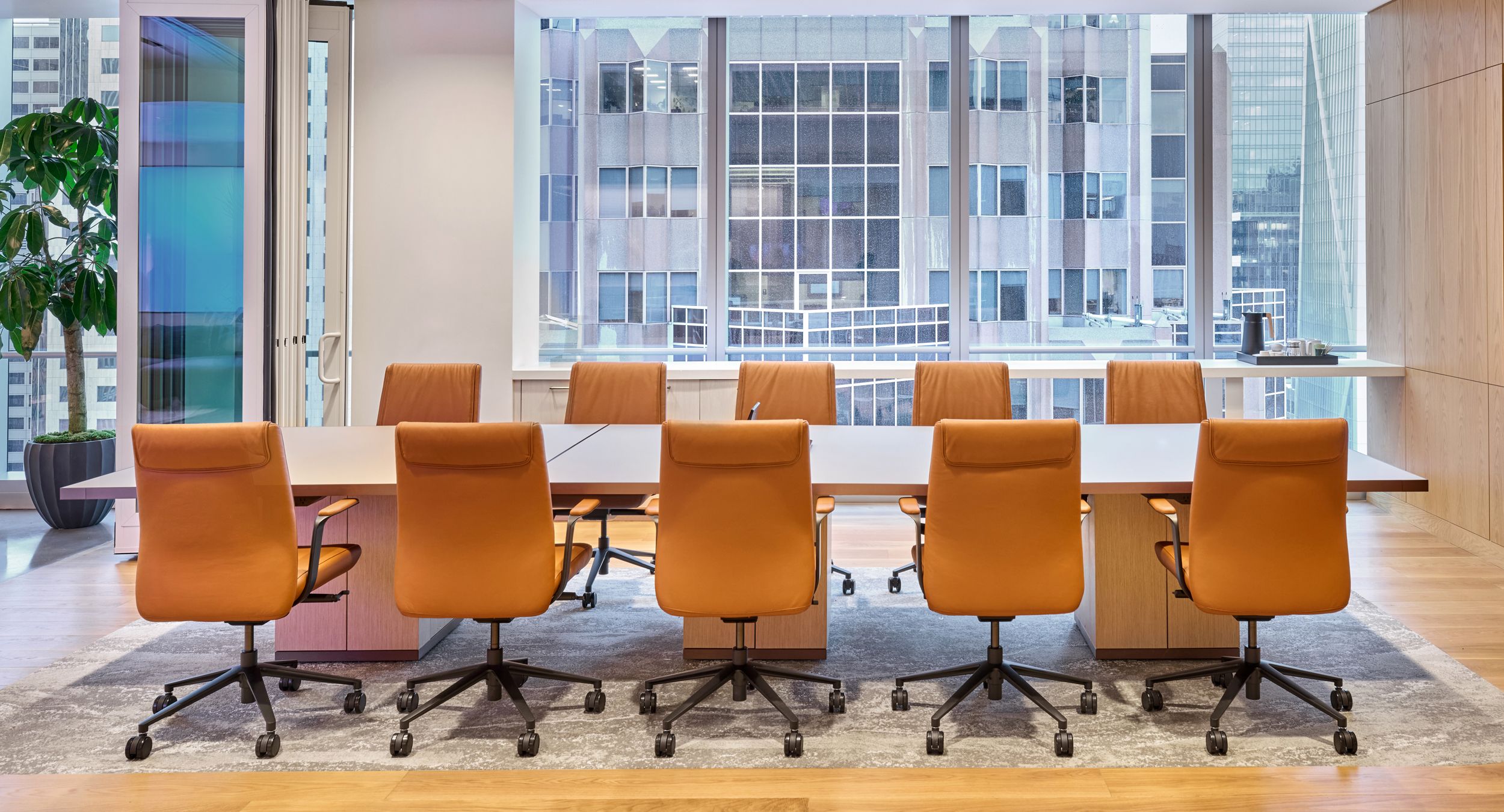 MOTUS tables with etched-glass surfaces and cube bases in Rift Cut White Oak.