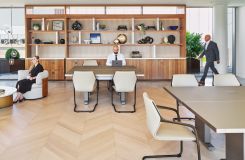 Etched glass surfaced Motus reconfigurable tables are a luxurious and functional addition to this shared space. thumbnail