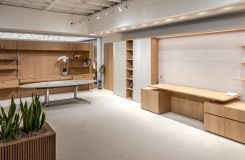 NEW MILLENNIA private office and storage wall in custom White Oak showcasing a new 1