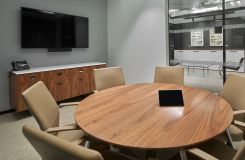 Round Stratos conference table complemented by a custom credenza in Figured Walnut and Deep Bronze. thumbnail