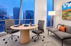 A small breakout room is centered by a round SESSIONS table in white Oak. thumbnail