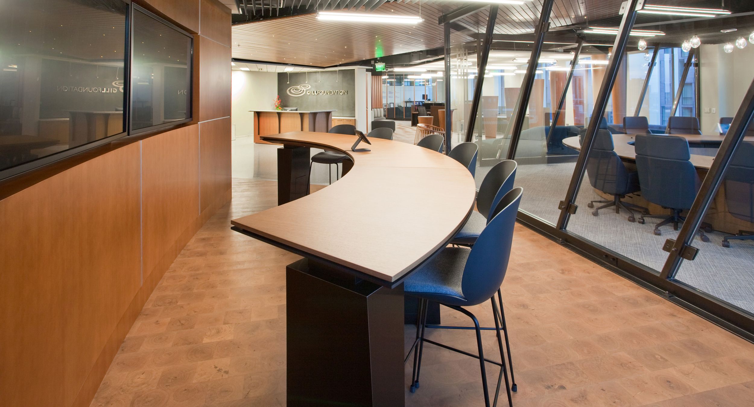 Custom-designed Mesa collaboration table in rift cut White Oak with Cosmos Black metal trim.