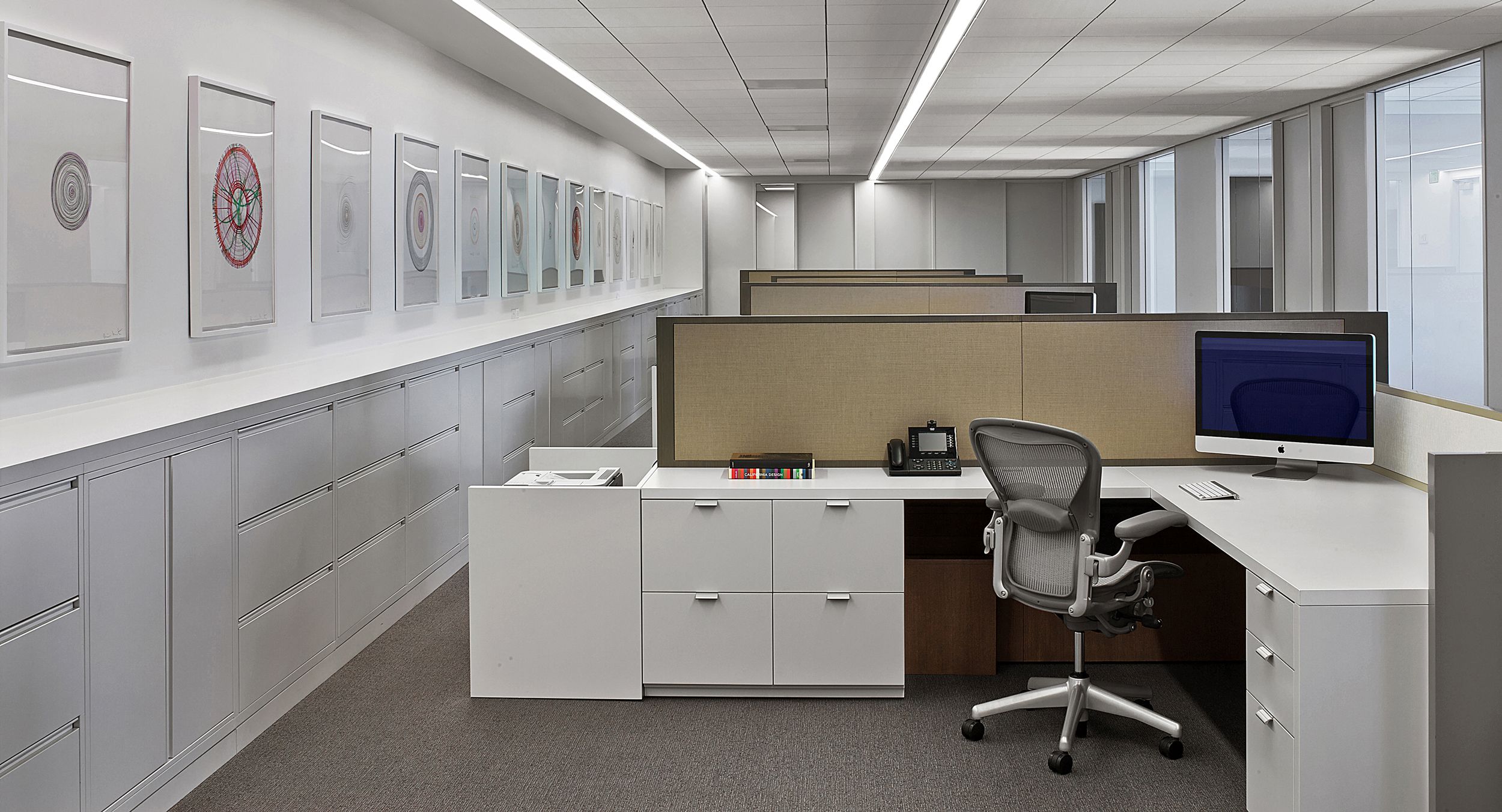 Open plan workstations feature white laminate and casework resulting in a beautiful, clean, and modern aesthetic.