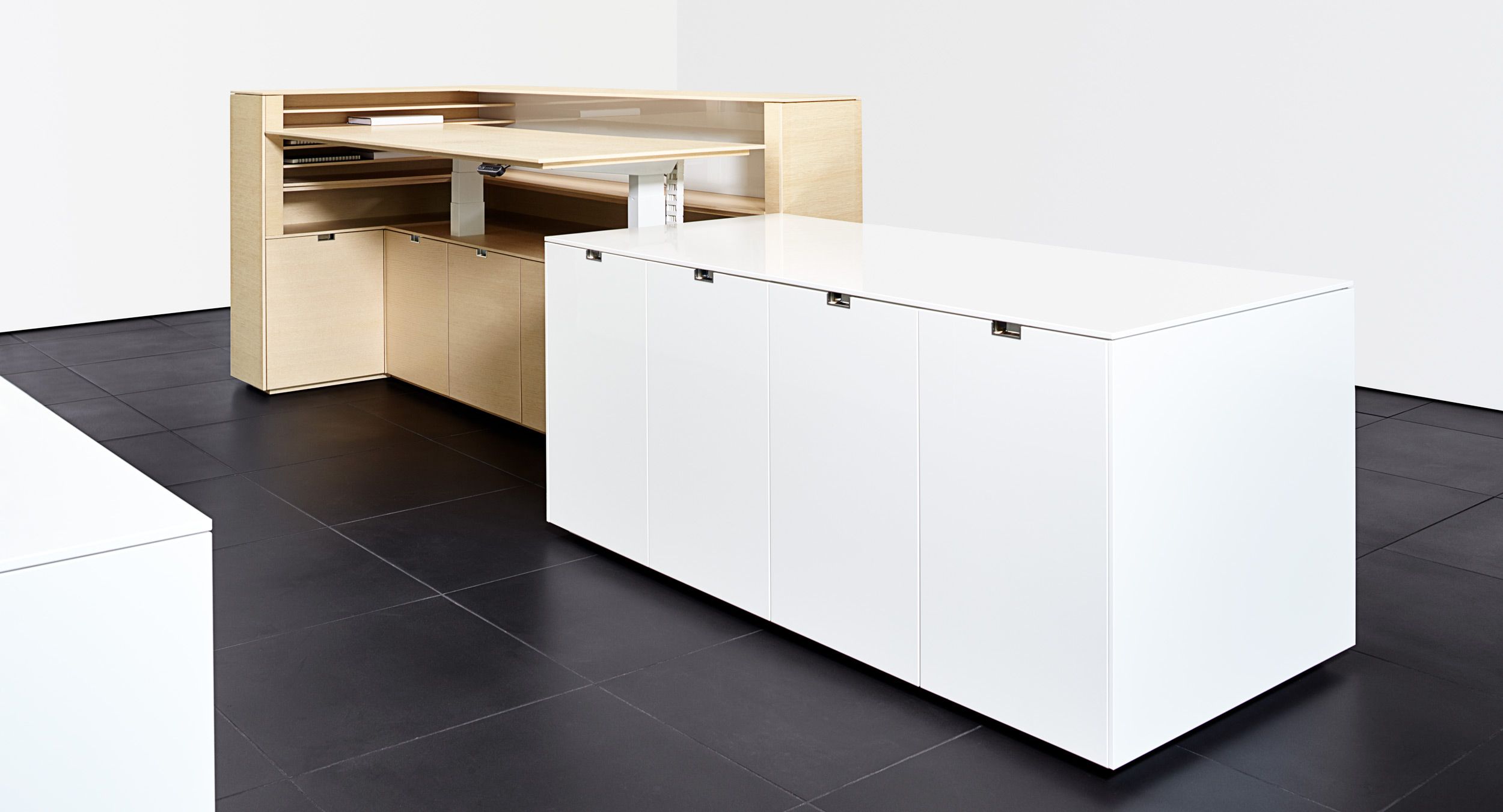 Adjustable-height desking fully integrates into reception furniture.