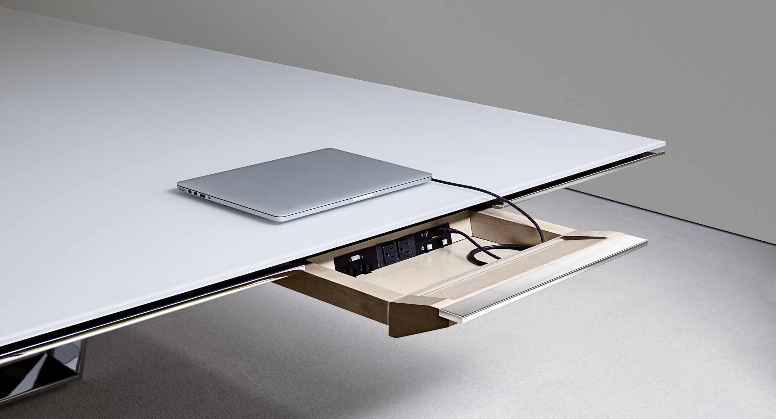 Eliminate surface clutter and comfortably access technology with innovative concealed drawers.