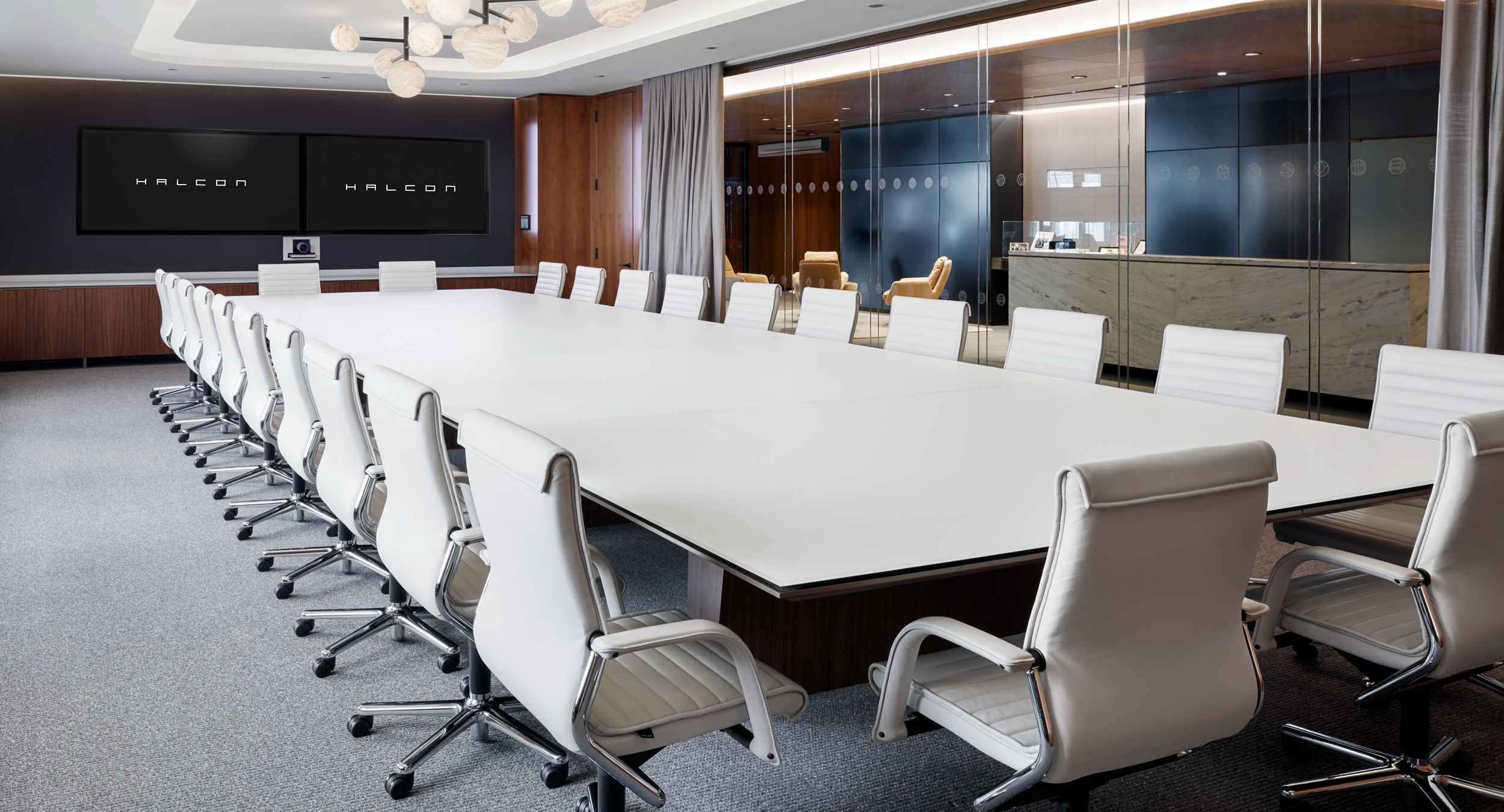 Extraordinary Mesa conference table with walnut panel base and etched glass surface sets an executive tone. Mesa signature credenza in coordinating finishes is the perfect complement for the space.