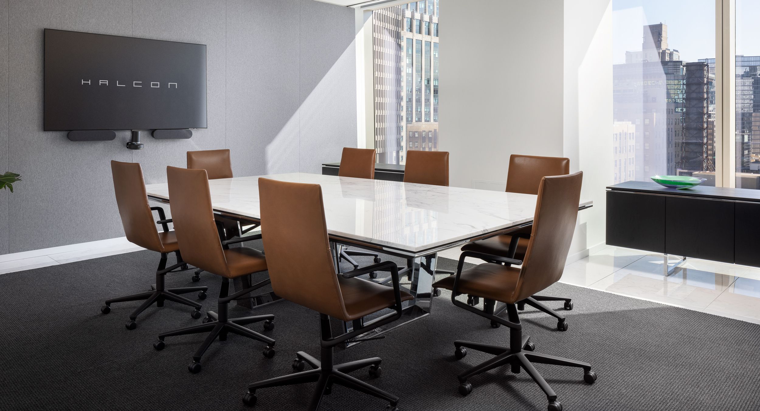 Mesa conference table with Calacatta marble surface and polished chrome loop base. A pair of Mesa signature credenzas in black oak and polished chrome are the perfect complement.