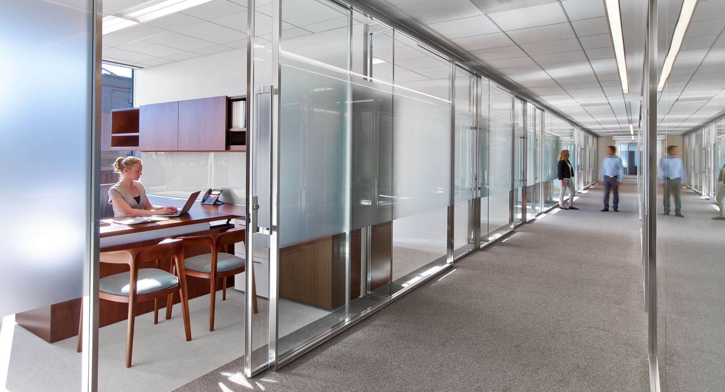 Associate offices feature integrated adjustable-height desking.