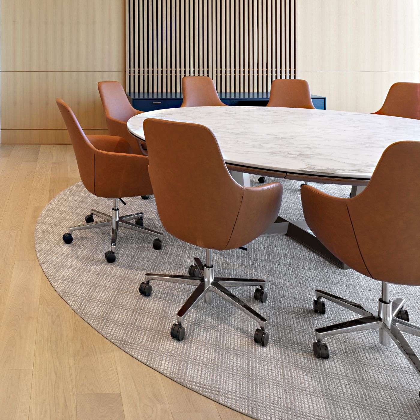 Round MESA table with stone surface and HALO sideboard complement the modern aesthetic of this conference room.