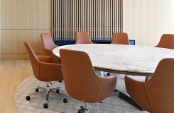 Round MESA table with stone surface and HALO sideboard complement the modern aesthetic of this conference room. thumbnail