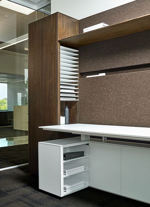 Project Manager offices were designed for quick access to active files.  This open storage faces toward the user, but is concealed from the hallway.   Innovative wall file slots were developed to cleanly provide additional active file storage.