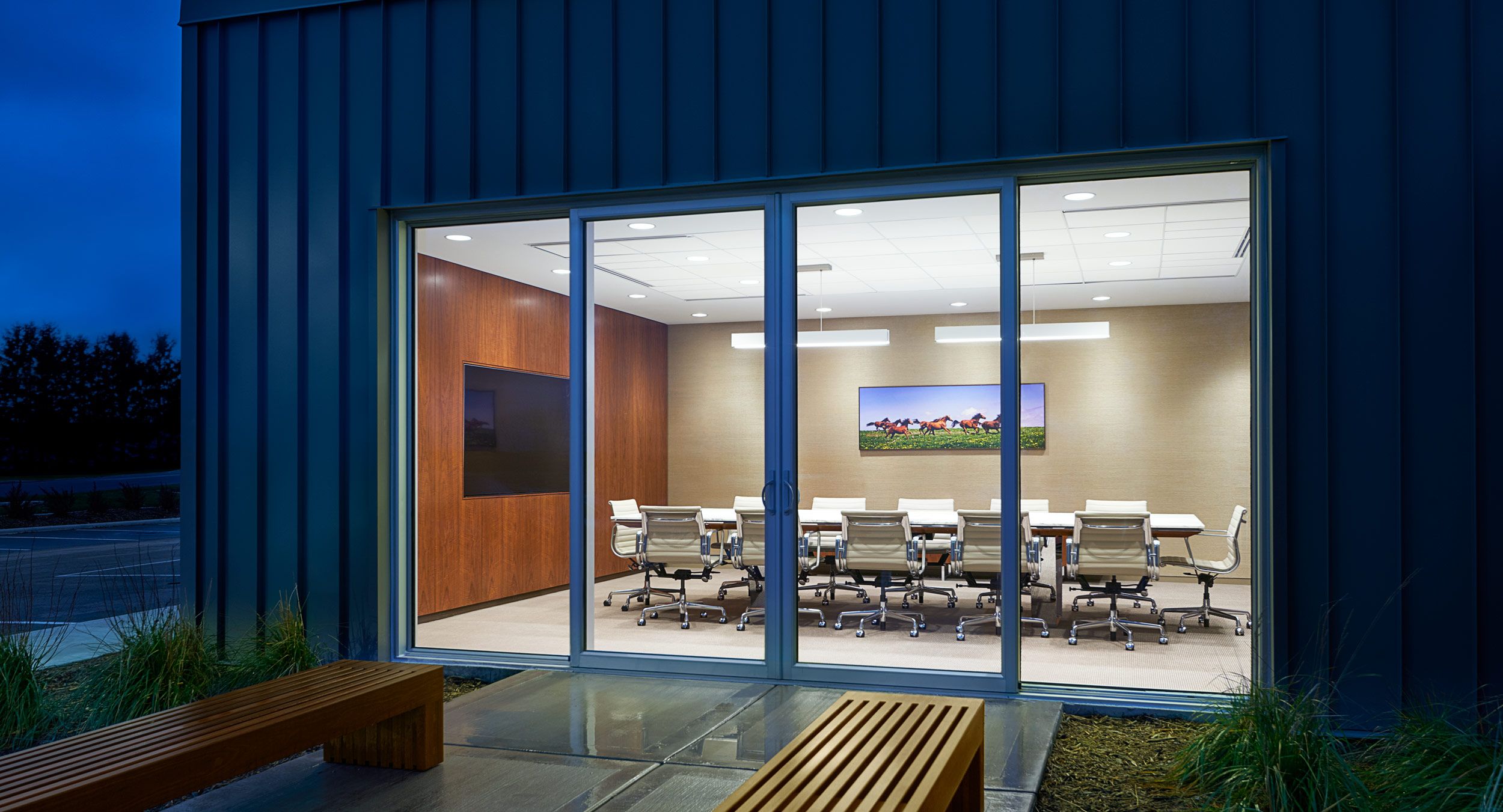 Our main conference room features a MESA table with a custom integrated media wall in Figured Walnut.