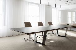 A MESA conference table with etched back-painted glass and polished chrome is the centerpiece of this airy conference room. thumbnail