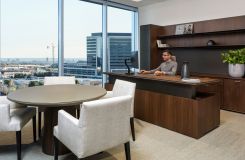 Adjustable-height HALO private office in smoked walnut and mink is complemented by a 42