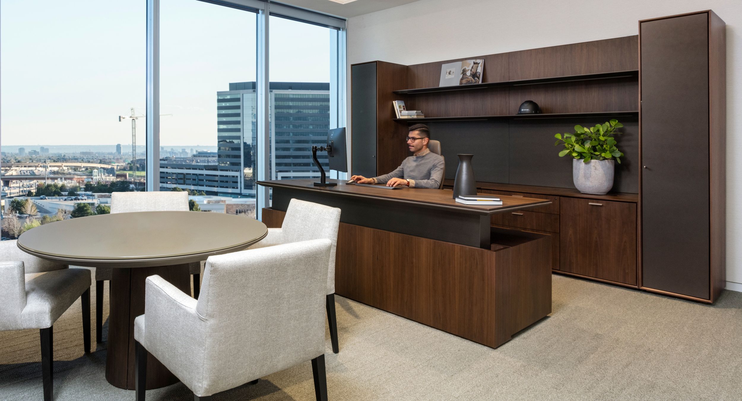 Adjustable-height HALO private office in smoked walnut and mink is complemented by a 42
