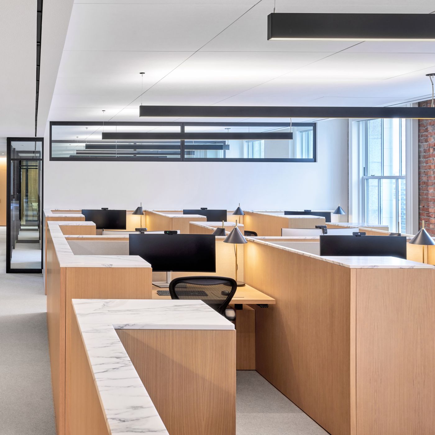 HALO OFFICE nine-seat workstations in white oak, deep bronze with Calcatta Arabescato tops.
