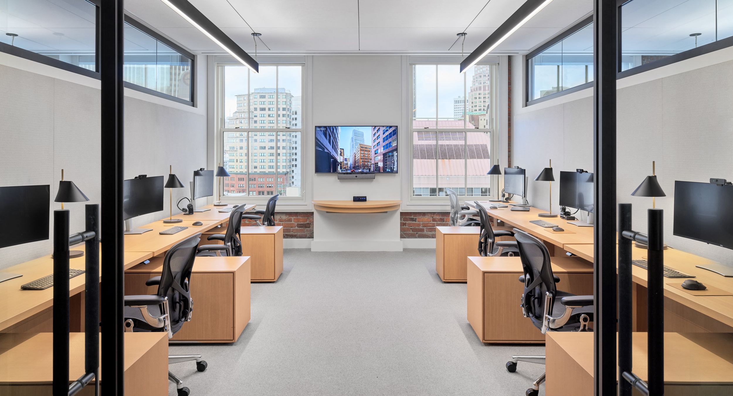 Custom HALO OFFICE workstations in white oak with deep bronze finger pulls.