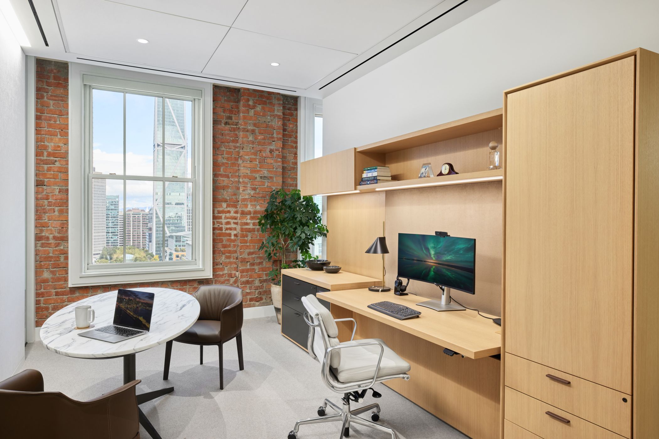 Custom HALO OFFICE with adjustable-height work surface in white oak, and deep bronze.  Calcatta Arabescato surfaced SESSIONS table is the perfect complement.