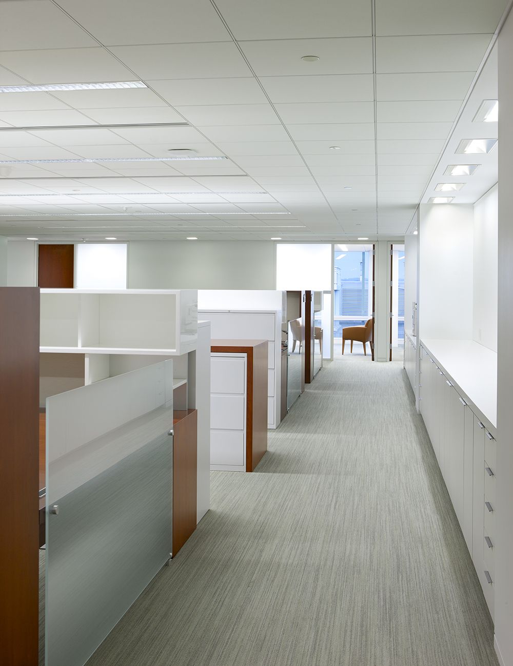 Etched Glass, Brushed Aluminum, and Fabric complement the seamless, compound mitered casework.
