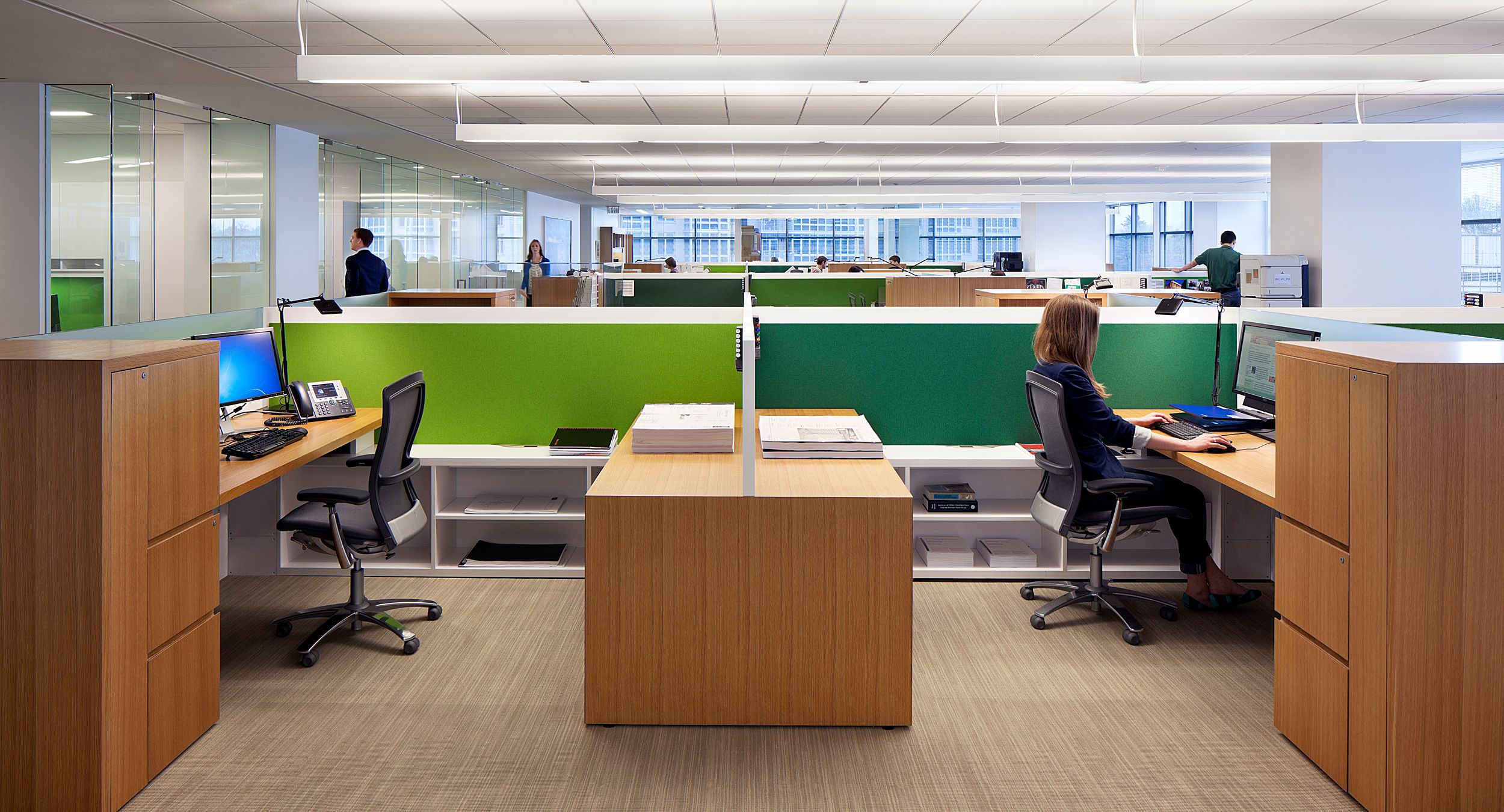 Each workstation cleanly integrates multiple storage options with glass, whiteboards, and tackable fabric to create a bright, beautiful, and functional open plan solution.